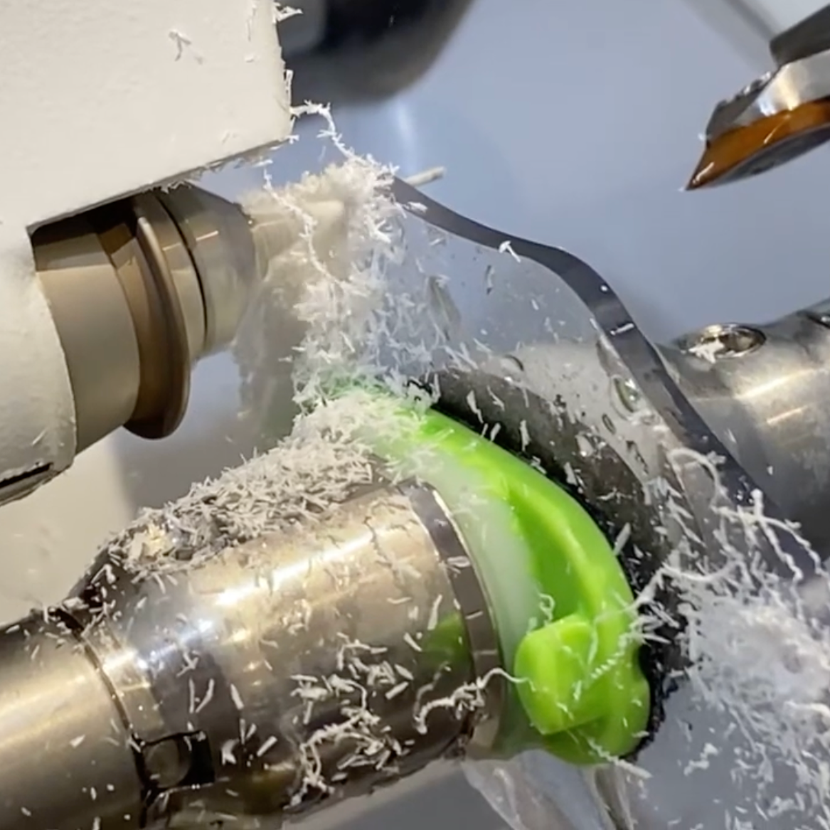 Cutting and shaping bespoke rimless prescription lenses during a Lens Art commission