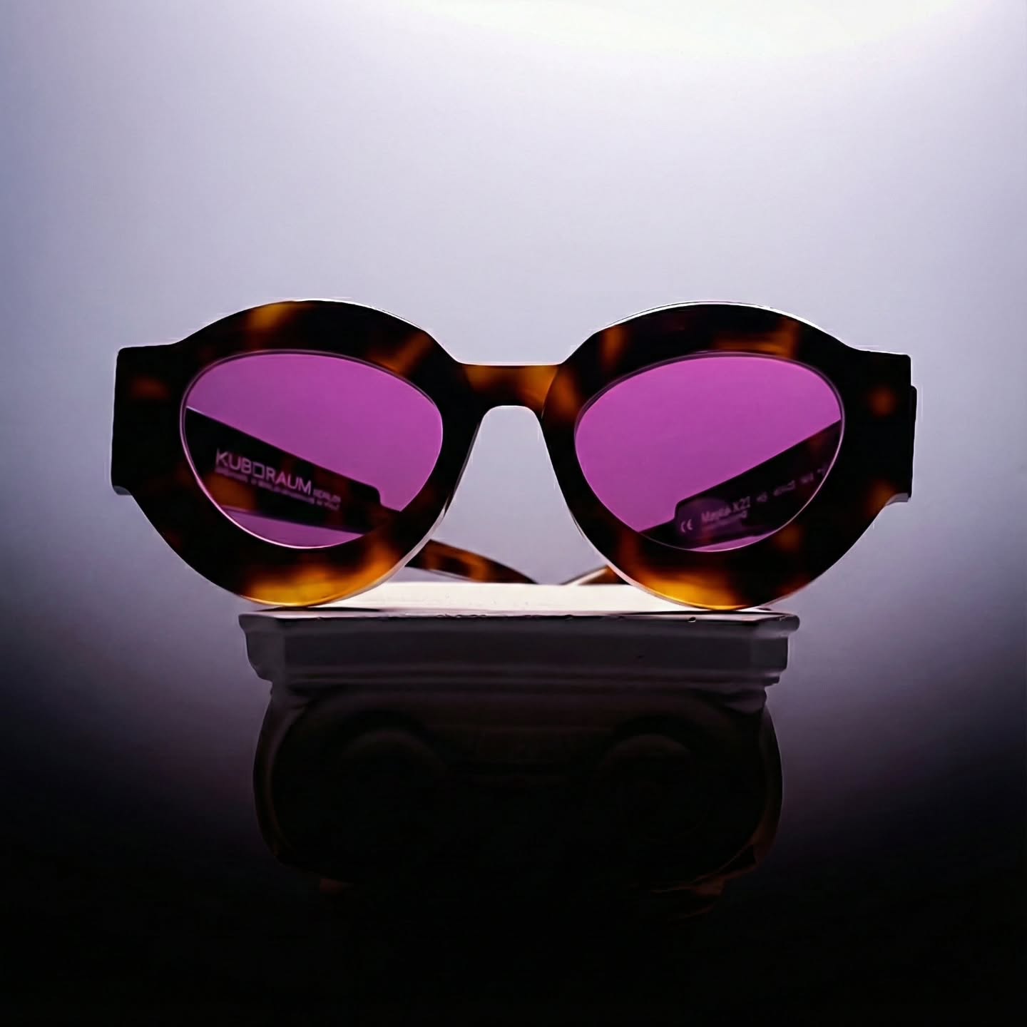 Kuboraum eyewear reglazed with bespoke custom tinted prescription lenses featuring Marma Dinamica Pink Rio photochromic technology through the Lens Art® luxury reglazing service.