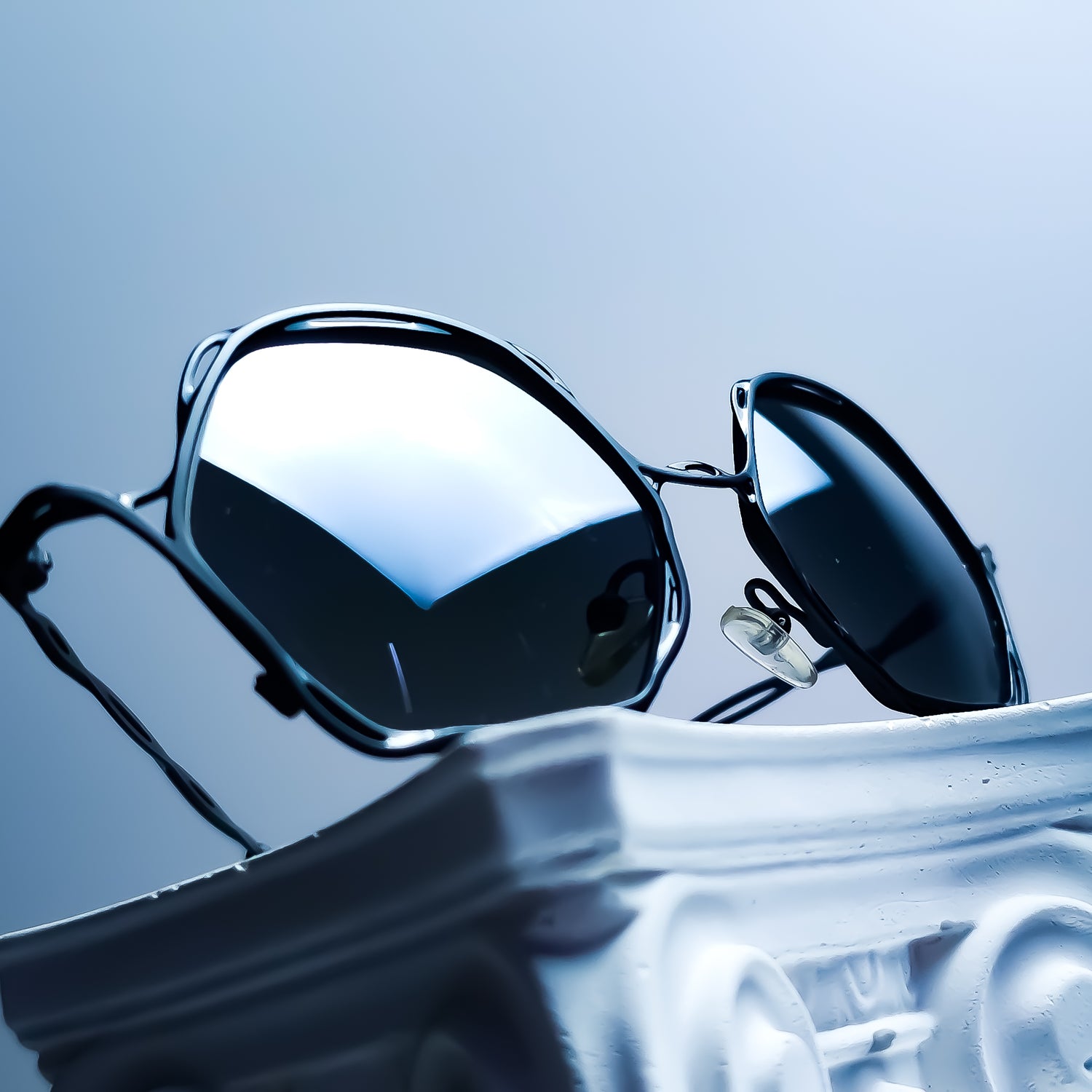 Lio Occhiali eyewear reglazed with bespoke Transitions® GEN S Grey photochromic lenses and a custom silver flash mirror finish through the Lens Art® luxury reglazing service.