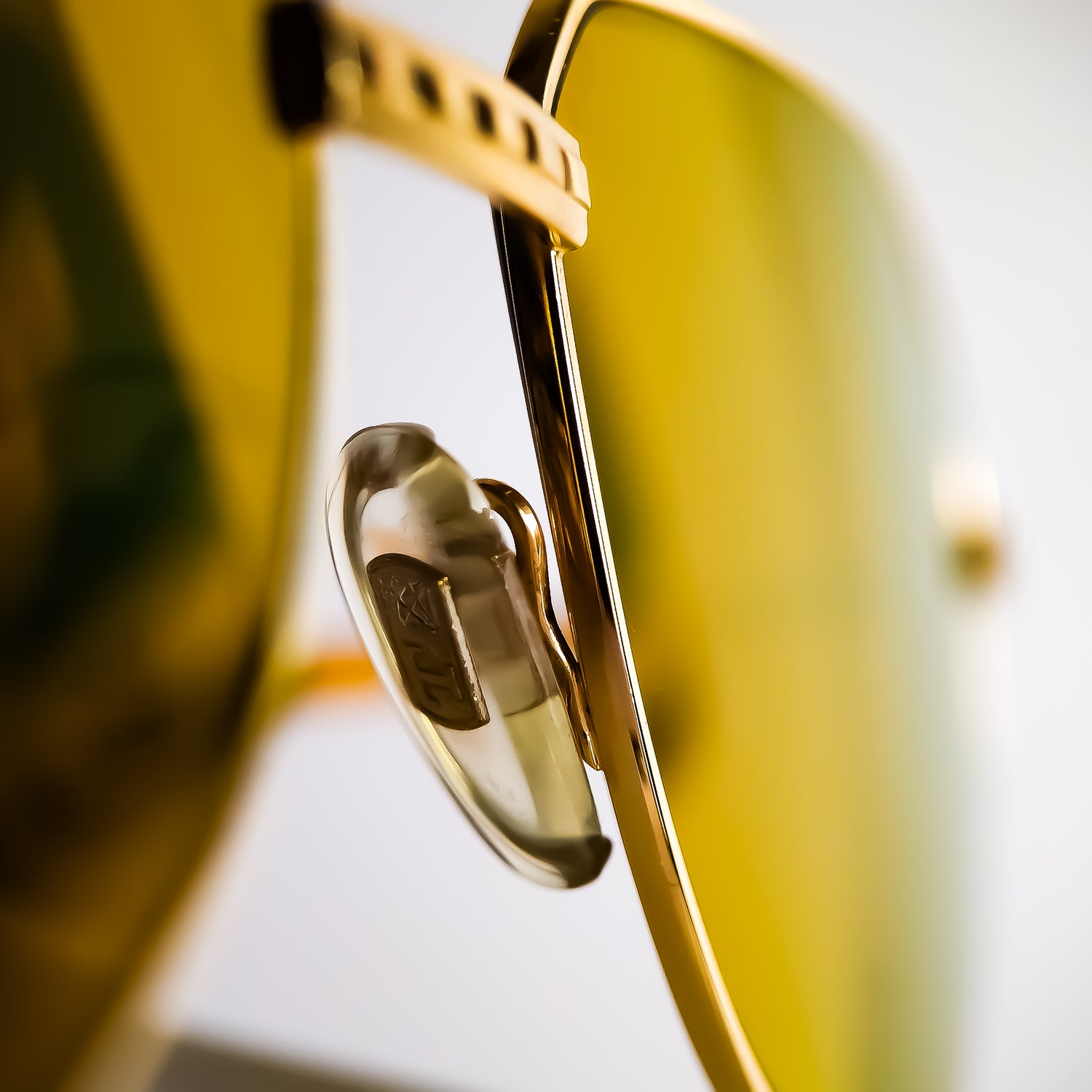 Close-up of vintage Tiffany Lunettes eyewear reglazed with bespoke brown gradient prescription lenses featuring Transitions® GEN S Brown photochromic technology and a custom gold flash mirror by Lens Art®.